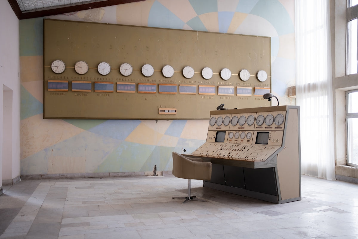 A room with a large wall mounted clock and a piano